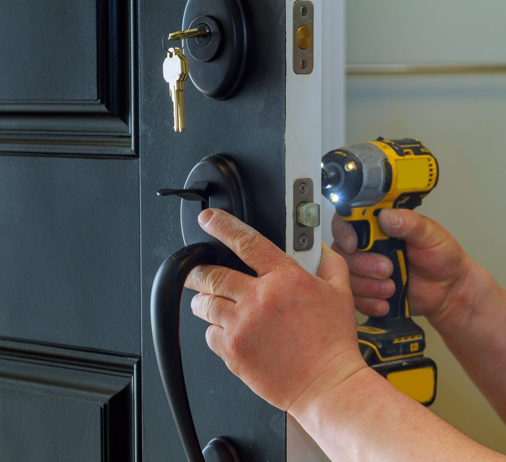 Close up of hands repairing a door