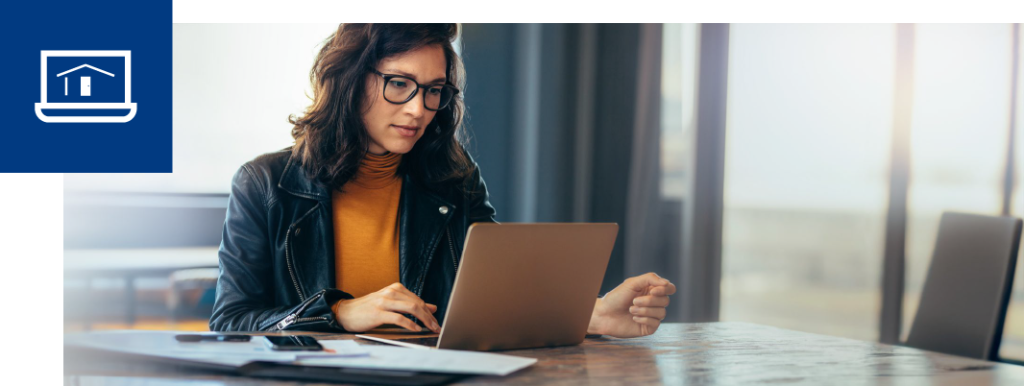 A woman wearing glasses uses a laptop to browse the Pillar To Post HomePage. A blue box in the top left corner has a white icon of a laptop with the Pillar To Post HomePage logo inside the screen.