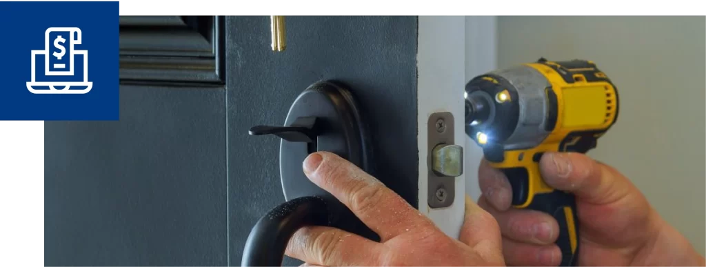 Close-up of hands installing a door lockset with a cordless drill.