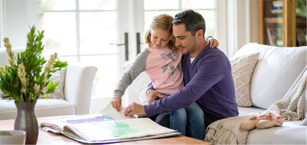 Parent and child looking at art book