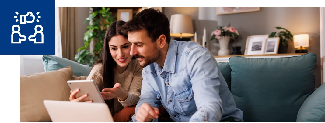 Two people in their home looking at a tablet together