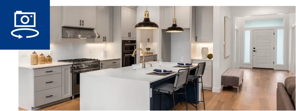 Modern white kitchen with island, pendant lighting, and open floor plan interior design
